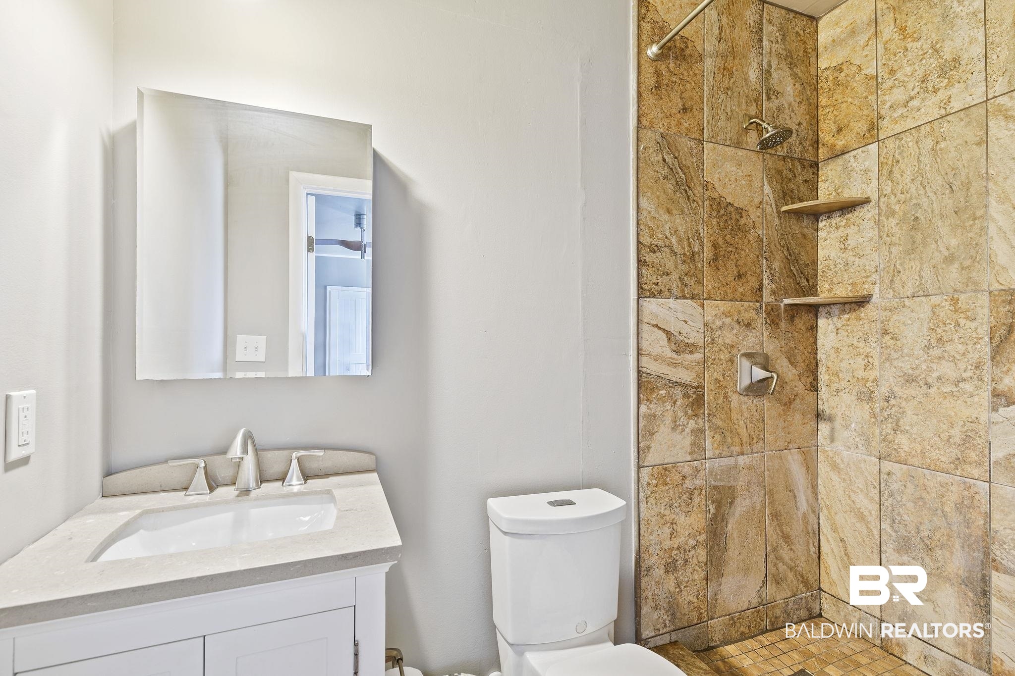 13108 6th Street Lillian, AL 36549 - Photo 21 of 39 Bathroom featuring vanity, toilet, and a tile shower