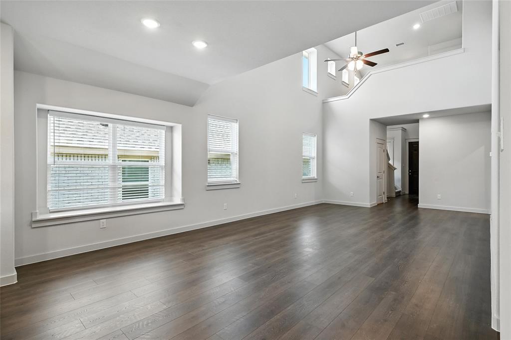 2623 Stowers Street Anna, TX 75409 - Photo 11 of 36 a view of an empty room with wooden floor and a window
