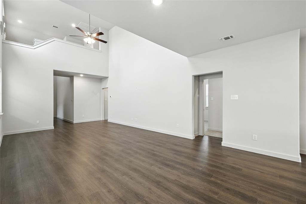 2623 Stowers Street Anna, TX 75409 - Photo 12 of 36 a view of an empty room with wooden floor and a ceiling fan