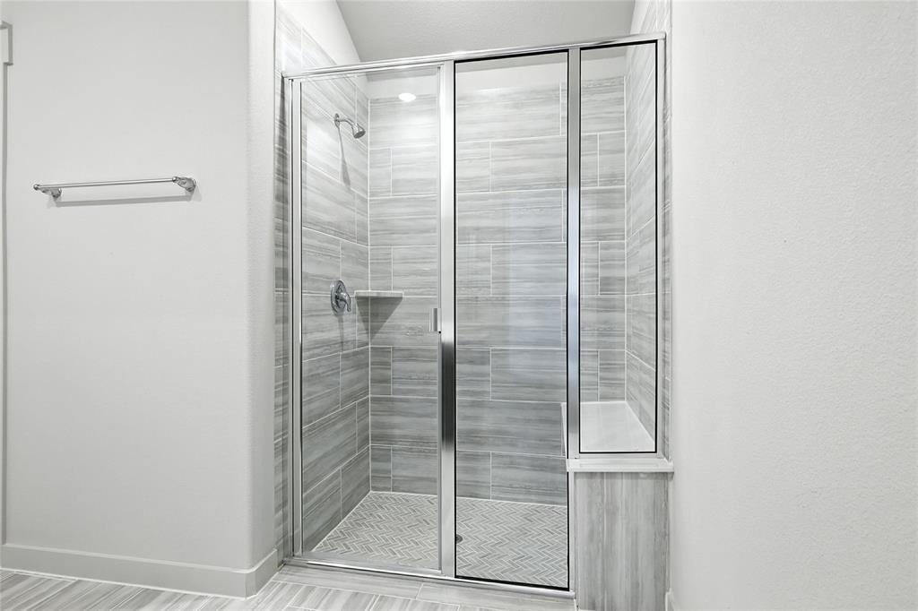 2623 Stowers Street Anna, TX 75409 - Photo 15 of 36 a bathroom with a glass shower door