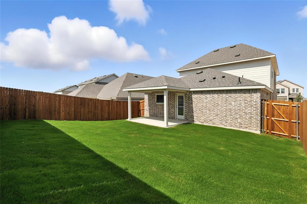 2623 Stowers Street Anna, TX 75409 - Photo 24 of 36 a view of a yard in front of a house with plants and large tree