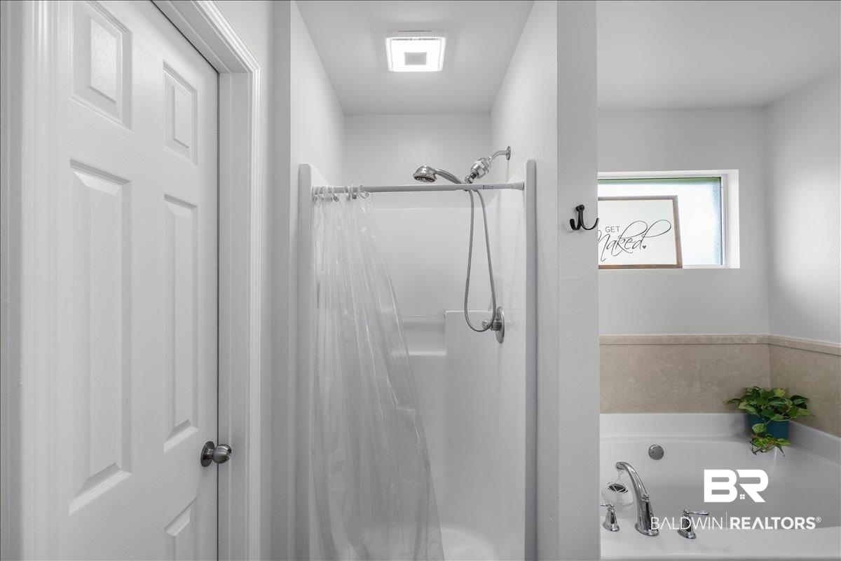 8952 Sherman Road Foley, AL 36535 - Photo 28 of 41 Shower and soaking tub combination with chrome fixtures and overhead lighting