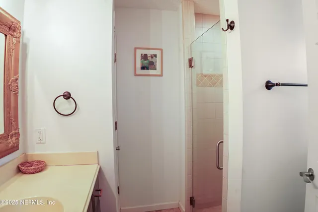 a living room with stainless steel appliances furniture and a flat screen tv