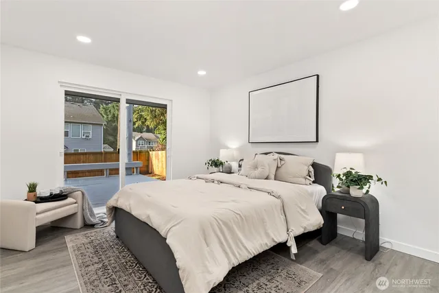 a bedroom with a bed and wooden floor