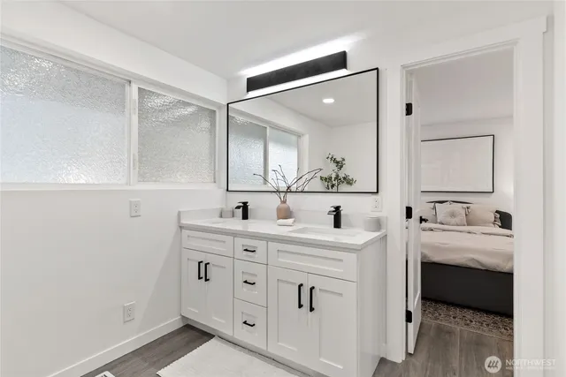 a spacious bathroom with a double vanity sink and mirror