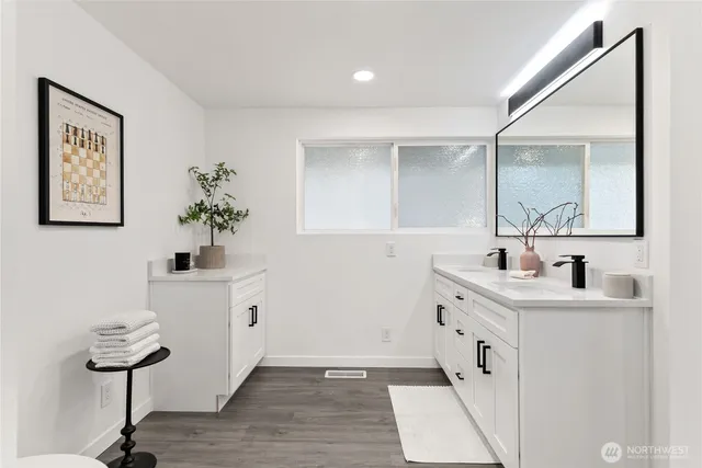 a room with a sink and a mirror