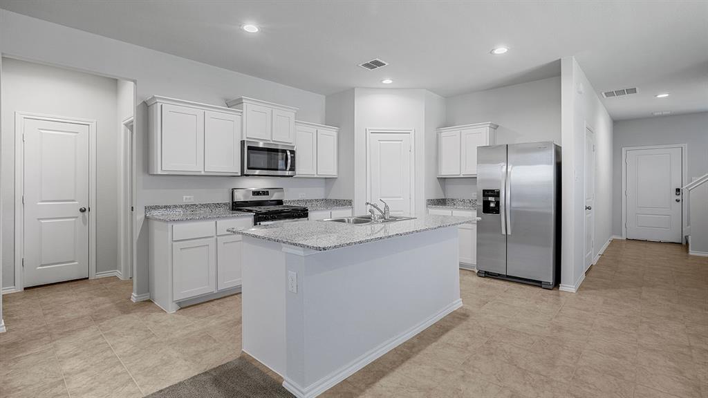 114 Mojave Road Boyd, TX 76023 - Photo 33 of 35 a kitchen with stainless steel appliances granite countertop a stove a sink and a refrigerator