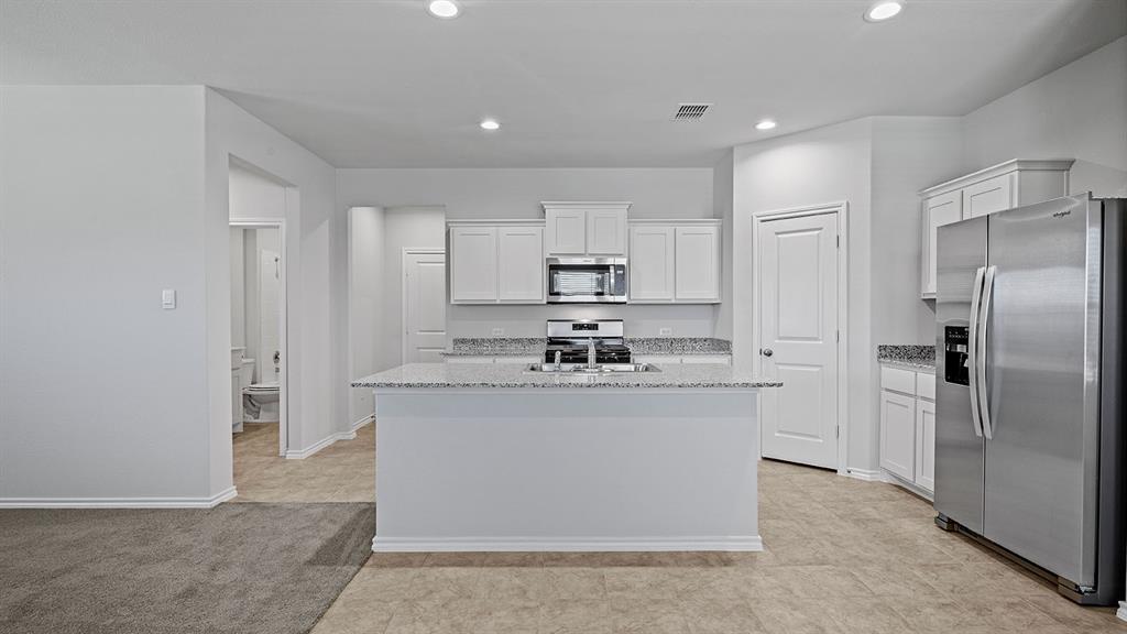 114 Mojave Road Boyd, TX 76023 - Photo 2 of 35 a kitchen with stainless steel appliances granite countertop a stove and a refrigerator