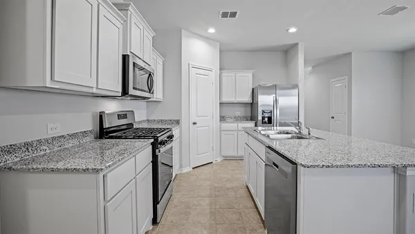 a kitchen with stainless steel appliances granite countertop a sink and cabinets