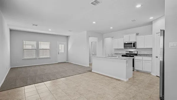 a kitchen with a sink stove and cabinets