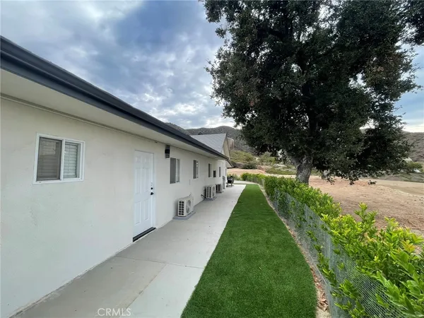 a view of a backyard of the house