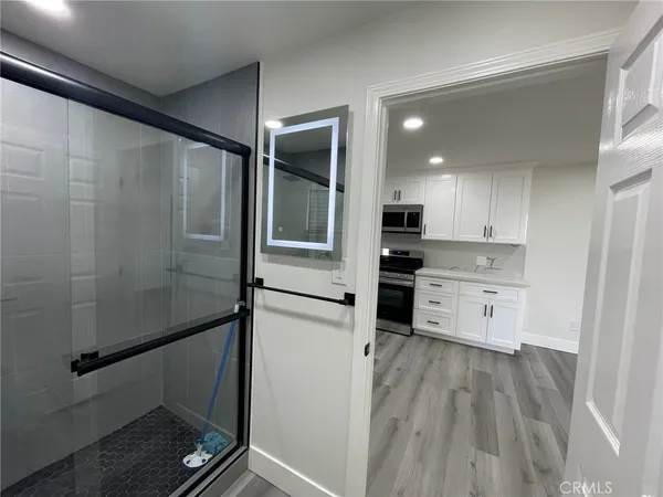 a kitchen with kitchen island white cabinets and stainless steel appliances
