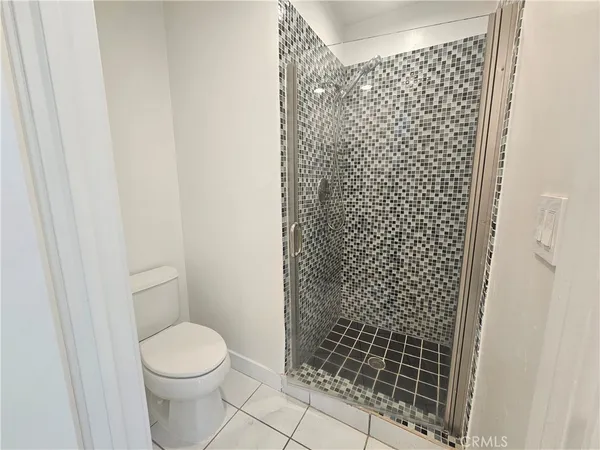 a white toilet sitting next to a shower curtain