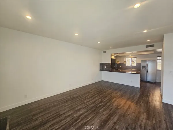 a view of a kitchen with a sink and wooden floor