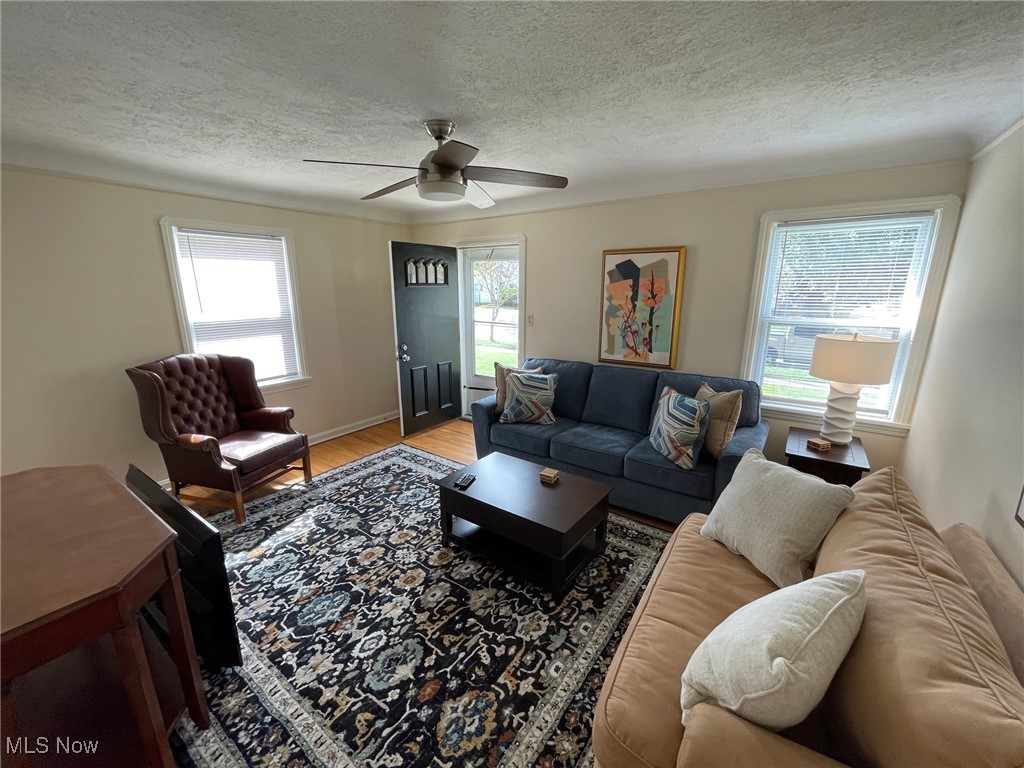 1539 Winchester Road Lyndhurst, OH 44124 - Photo 3 of 21 Living room with ceiling fan, a wealth of natural light, and wood flooring