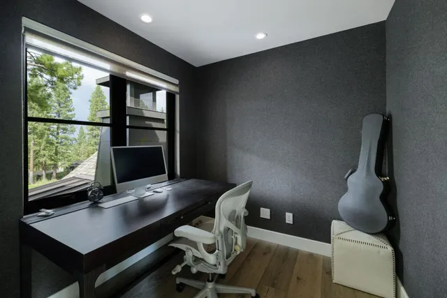 a view of a workspace with furniture and a window