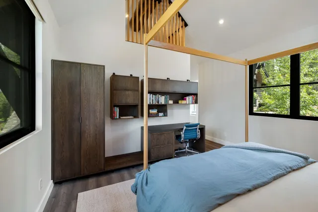 a bedroom with a bed and wooden floor