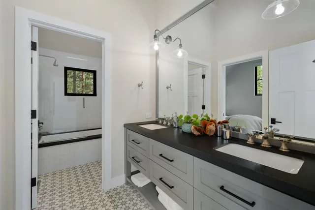 a bathroom with a double vanity sink and mirror