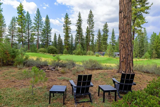 a view of a chairs and table in the garden