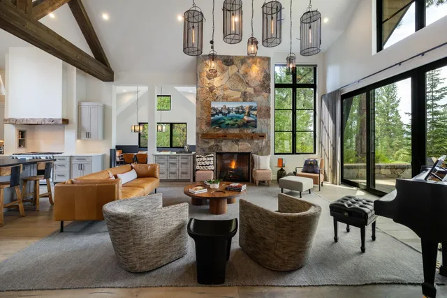 a living room with fireplace furniture and a large window