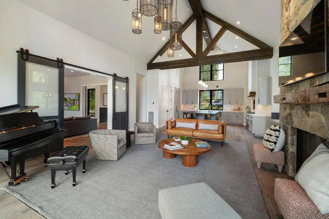 a living room with furniture a fireplace and a large window