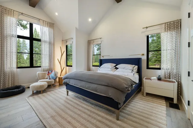 a bedroom with a large bed and a large window