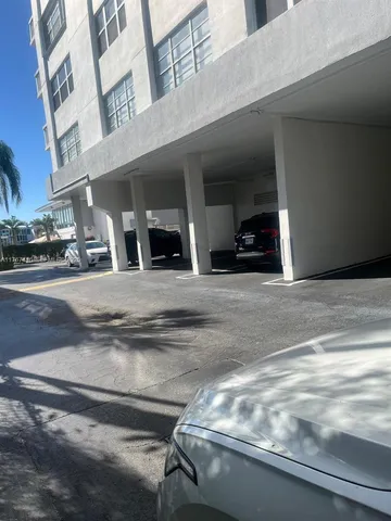 a bedroom with a bed and a flat tv screen on dresser