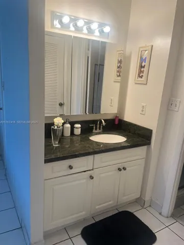 a living room with furniture a window and a potted plant