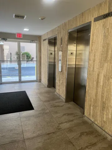 a front view of multiple houses with yard