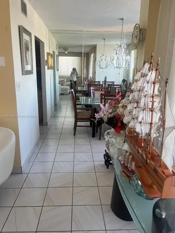 a dining room with furniture a chandelier and window