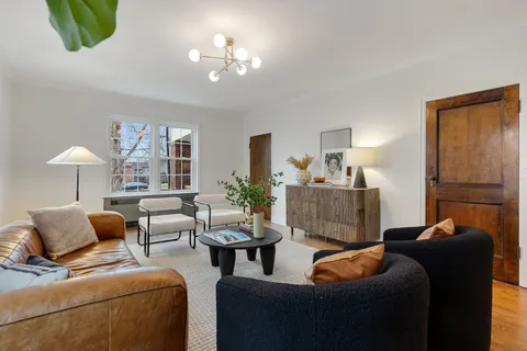 a living room with furniture and a lamp