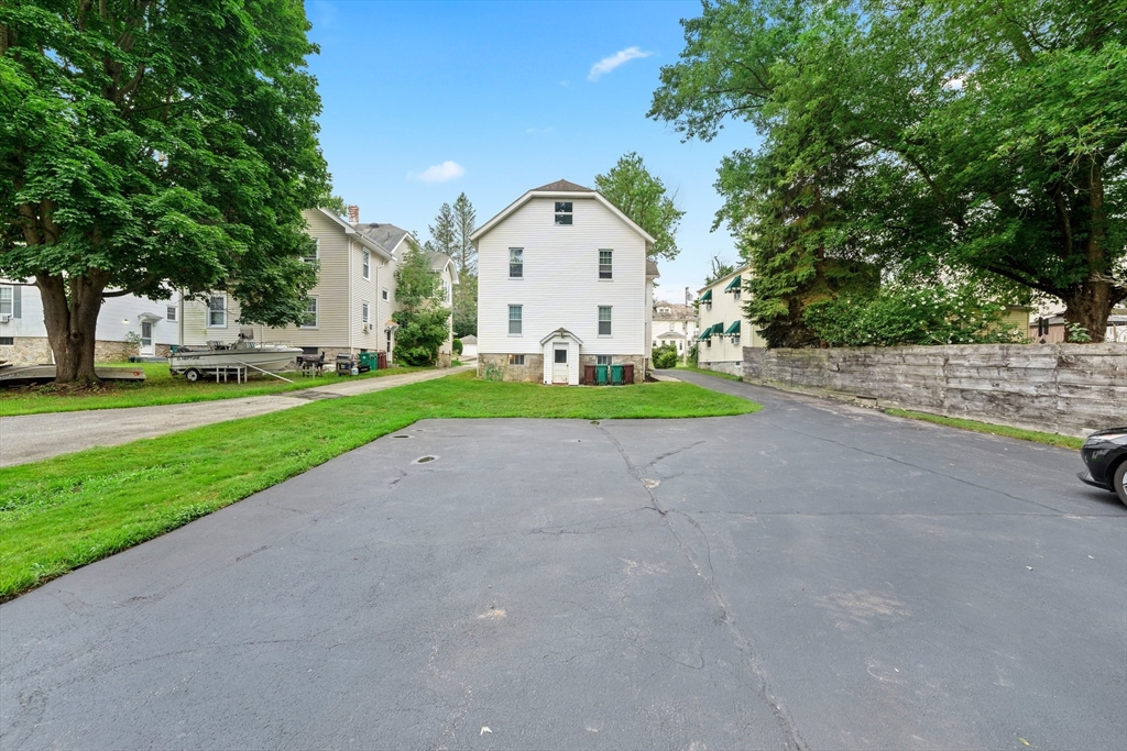 90 Meadow Road Woonsocket, RI 02895 - Photo 16 of 18 a view of a white house with a big yard and large trees