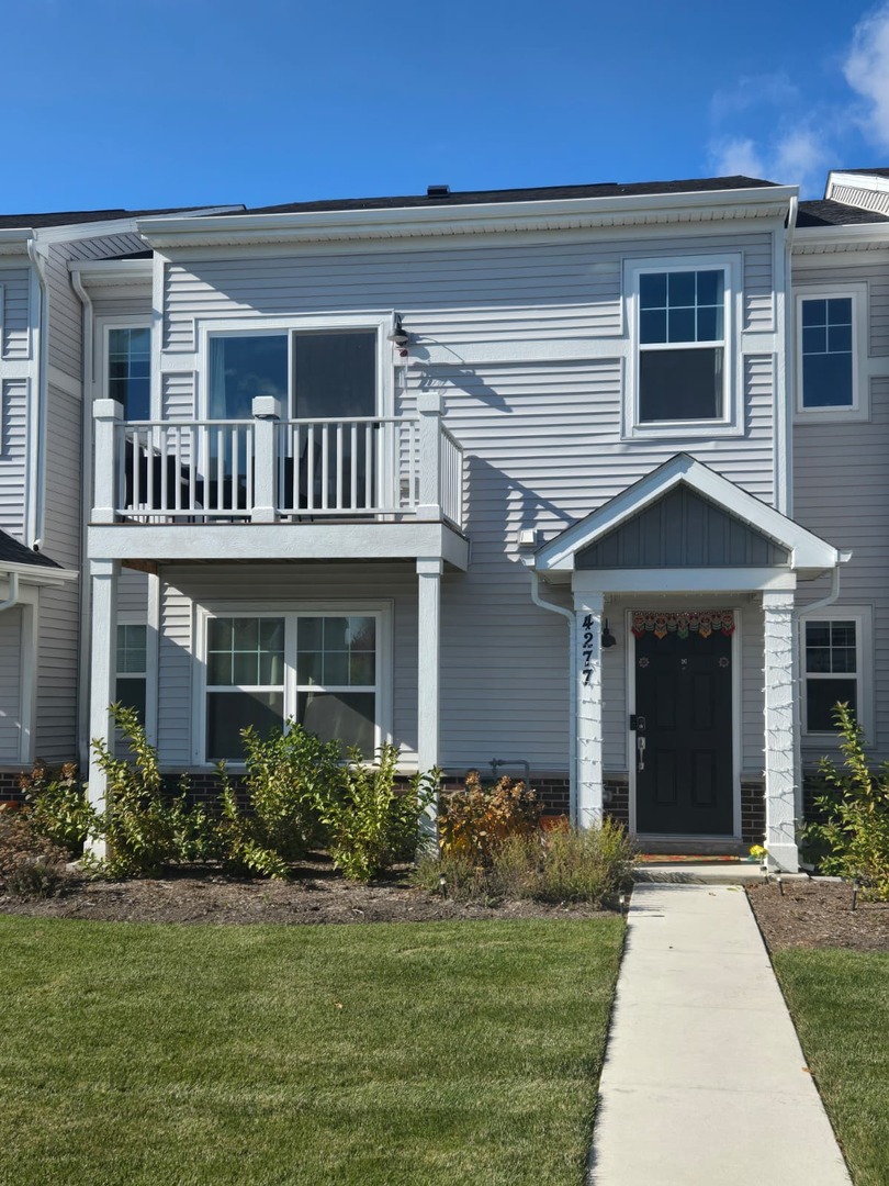 a front view of a house with garden and porch