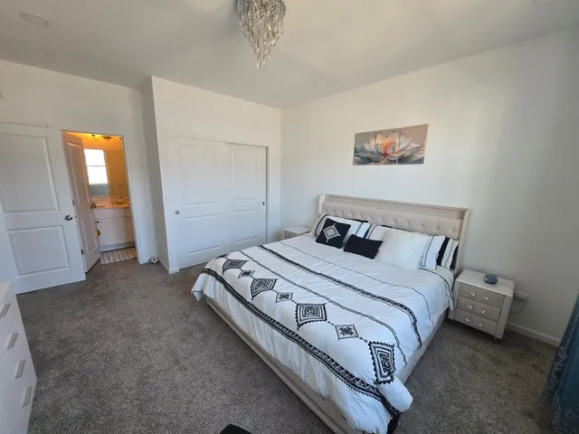 a bedroom with a bed and a mirror