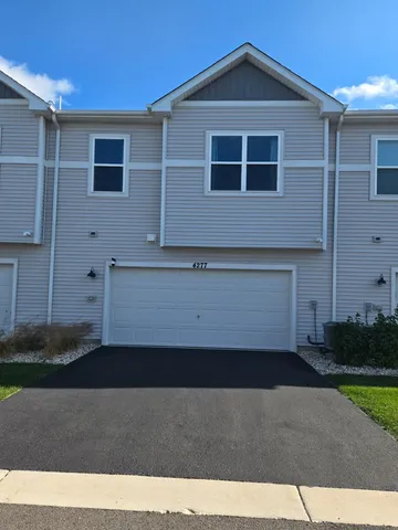 a front view of a house with garage