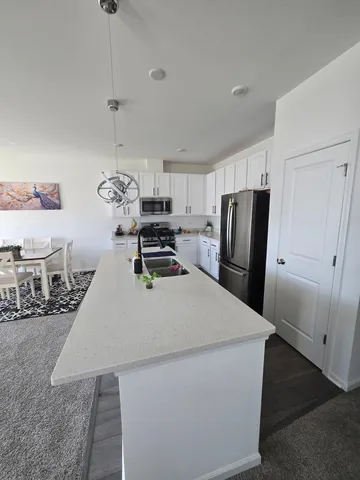 a kitchen with stainless steel appliances a refrigerator sink and wooden cabinets