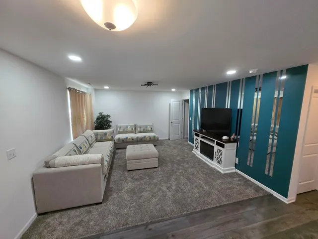 a living room with furniture and a flat screen tv