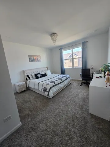 a spacious bedroom with a bed and a couch