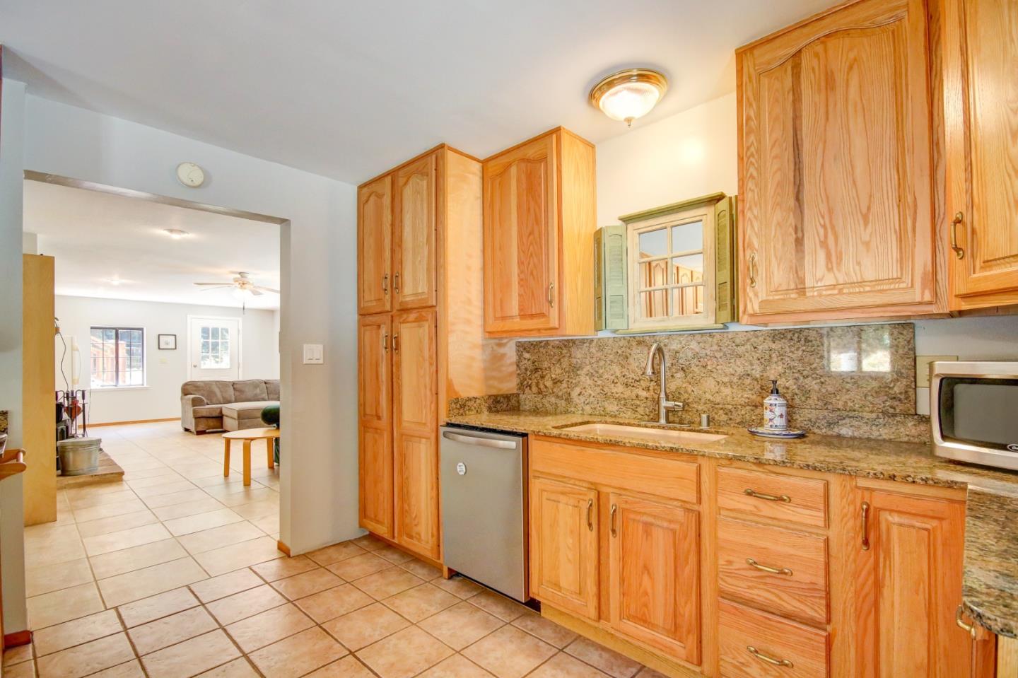 500 Hidden Canyon Watsonville, CA 95076 - Photo 25 of 37 a kitchen with granite countertop a sink and cabinets