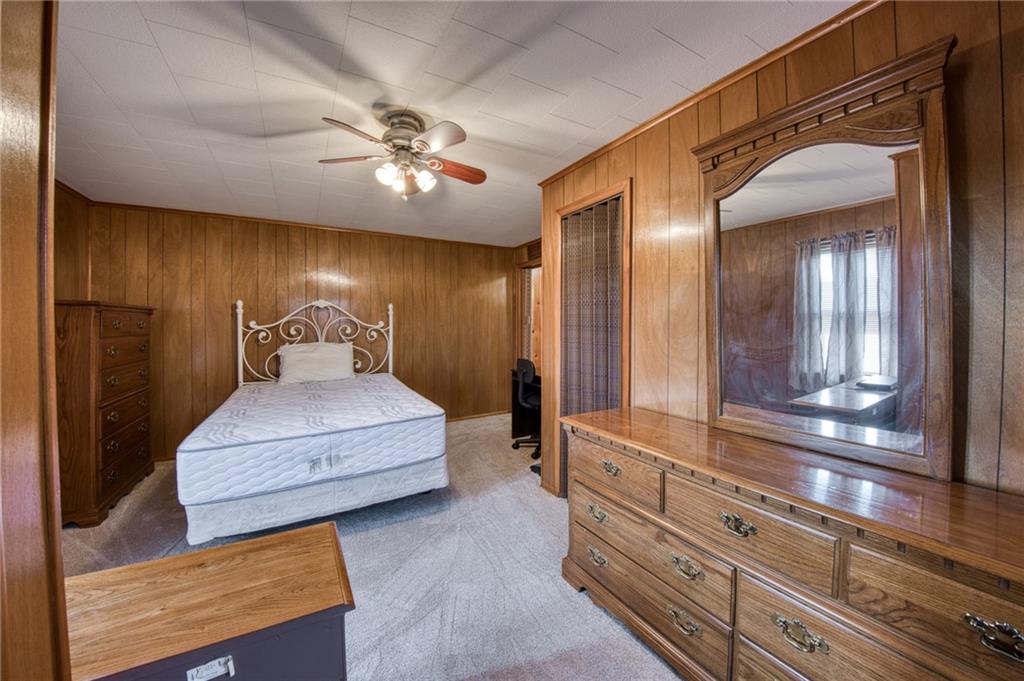 51 Sycamore Street Muse, PA 15350 - Photo 20 of 38 a spacious bedroom with a bed and a chandelier
