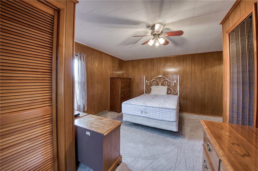 51 Sycamore Street Muse, PA 15350 - Photo 21 of 38 a bedroom with a bed and a chandelier
