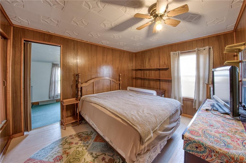 51 Sycamore Street Muse, PA 15350 - Photo 23 of 38 a bedroom with a bed and a flat tv screen on dresser