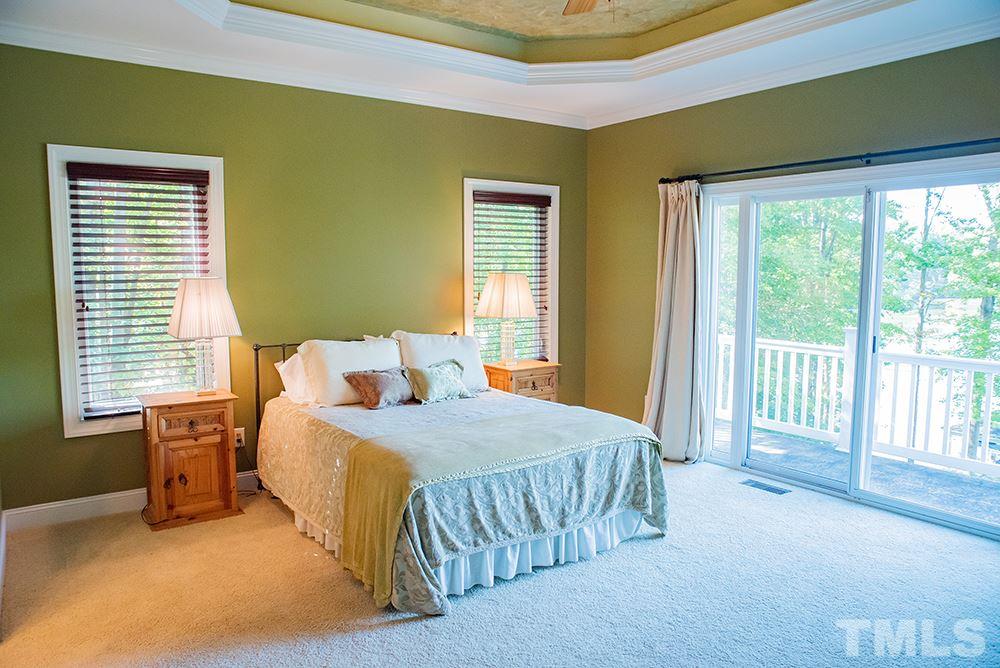 159 Duck Pointe Drive Roxboro, NC 27574 - Photo 14 of 30 a bedroom with a bed and a night stand