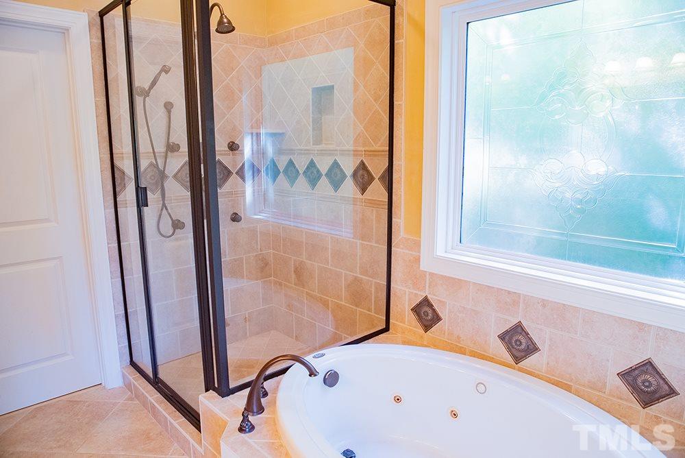 159 Duck Pointe Drive Roxboro, NC 27574 - Photo 15 of 30 a bathroom with a tub and a shower