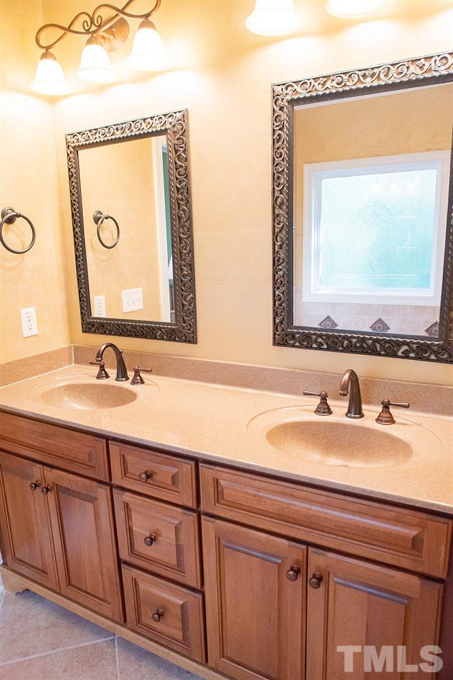 159 Duck Pointe Drive Roxboro, NC 27574 - Photo 16 of 30 a bathroom with a granite countertop sink and a mirror