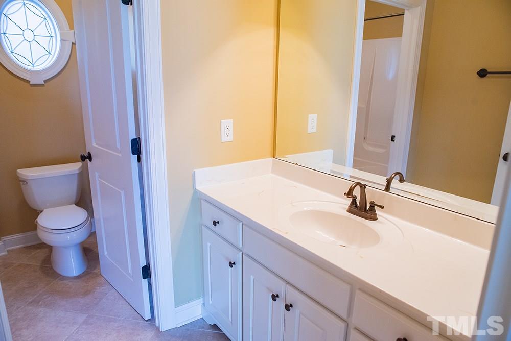 159 Duck Pointe Drive Roxboro, NC 27574 - Photo 18 of 30 a bathroom with a toilet a sink and a mirror