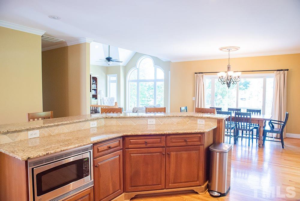 159 Duck Pointe Drive Roxboro, NC 27574 - Photo 22 of 30 a kitchen with a stove a sink and a dining table