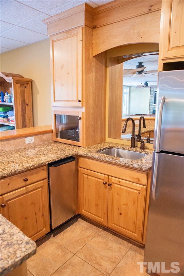 159 Duck Pointe Drive Roxboro, NC 27574 - Photo 23 of 30 a kitchen with granite countertop stainless steel appliances a sink window and cabinets