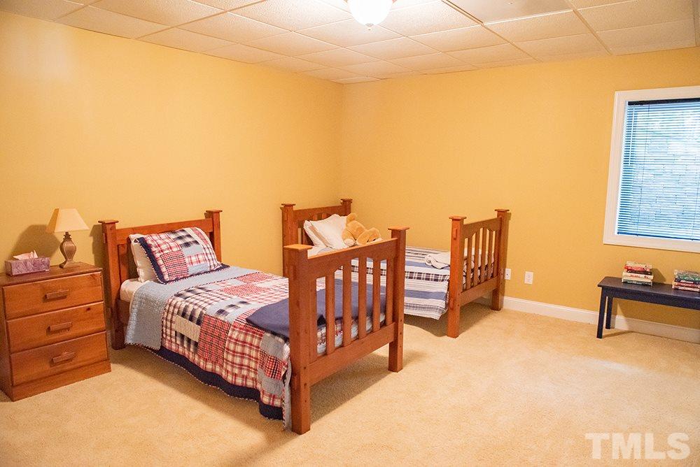159 Duck Pointe Drive Roxboro, NC 27574 - Photo 24 of 30 a spacious bedroom with two beds and painting on the wall