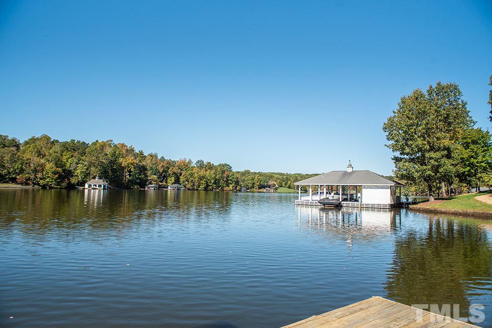 159 Duck Pointe Drive Roxboro, NC 27574 - Photo 4 of 30 a view of a lake with houses